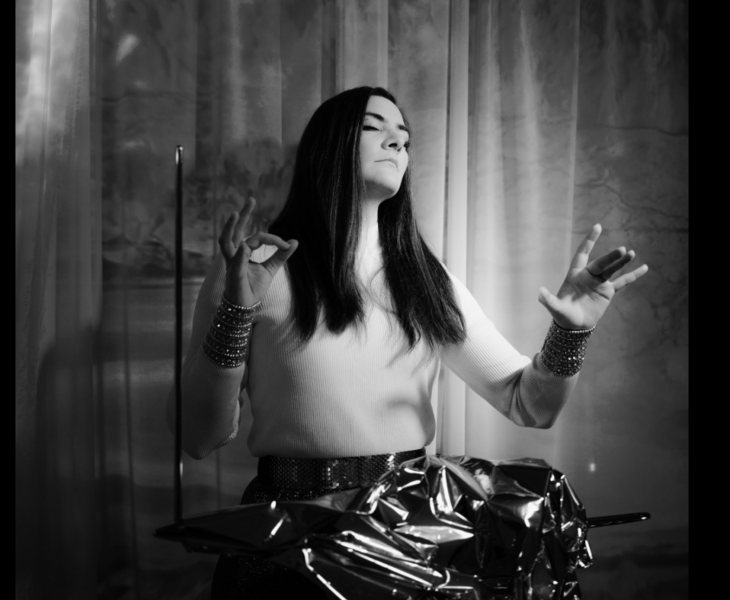 A Woman with long hair playing the Theremin