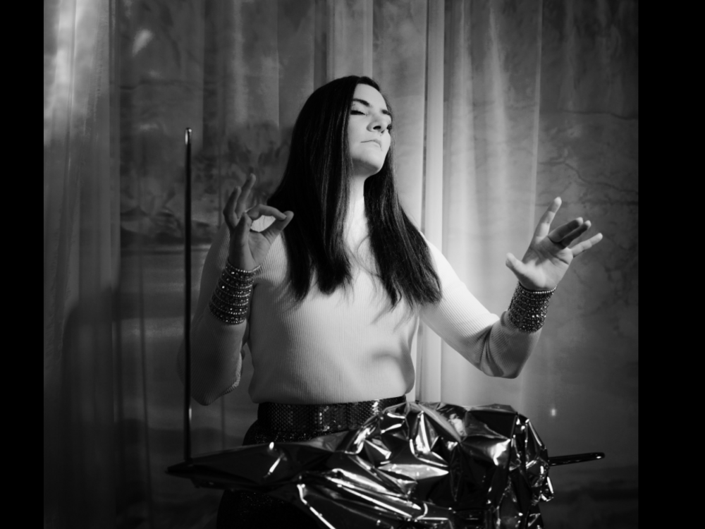 A Woman with long hair playing the Theremin